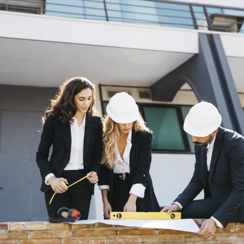 three-architects-wearing-helmets